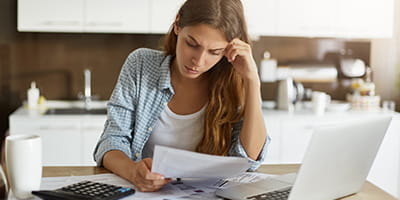 young-woman-checking-her-budget-doing-taxes-min.jpg